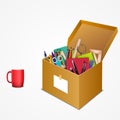 Office accessories in a cardboard box with a mug Royalty Free Stock Photo