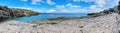 Panoramic view of secluded sea bay with turquoise water and rocky shore