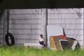 Illustration Photo, Gadget addicted, Sitting Man Holding Smartphone at swinging from used car tire in the yard Royalty Free Stock Photo