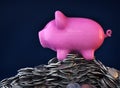 Pink piggy bank, ceramic shiny, on pile of 50 cents USA coins, on dark background, 3d render Royalty Free Stock Photo