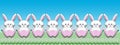Illustration of a row of white Easter bunnies sitting in a field