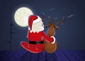 Santa Claus and reindeer on the roof in the moonlight Royalty Free Stock Photo