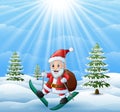 Santa claus skiing in the snow hill with sack of gifts Royalty Free Stock Photo