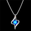 silver pendant on a chain with a precious stone