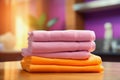 illustration of a stack of pink and orange colored towels on a wooden surface