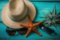 Illustration for summer vacation of a Hat, glasses, and starfish on a blue wooden background, in the style of serene seascapes.