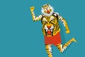 A man with body painted with tiger stripes dancing during the festival of Onam in Kerala, Indi Royalty Free Stock Photo