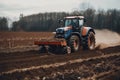 Tractor driving across large field making special beds for sowing seeds into purified soil. Agricultural vehicle works in the