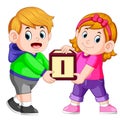 Two kids carrying alphabet block