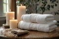Two towels on a table next to candles and a spa, high quality, high resolution Royalty Free Stock Photo