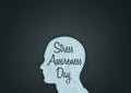 An illustration of a unisex silhouette of a human head containing Stress Awareness Day with dark background and copy space and