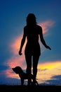 Woman runs with the dog at sunset