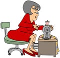 Seamstress sitting at a sewing machine