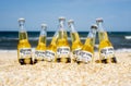 Illustrative editorial of Corona beer bottles on the beach sand: GENICHESK, UKRAINE - 19 June 2021 Royalty Free Stock Photo