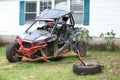 Illustrative editorial image of a wrecked Polaris RZR