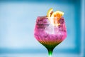 Illustrative Editorial of Tanqueray Gin branded cocktail glass containing a pink carbonated soda drink