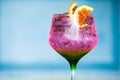 Illustrative Editorial of Tanqueray Gin branded cocktail glass containing a pink carbonated soda drink