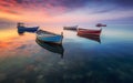 Illustrative figure of small fishing boats moored near the coast. Sunset light. Generative AI. Royalty Free Stock Photo