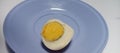 Illustrative photo of a boiled egg halved, on a plate