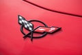 Closeup of  Corvette logo on red car parked at fun car show event Royalty Free Stock Photo