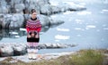 Young inuit woman in traditional clothing posing for photos in a small Greenlandish village. Royalty Free Stock Photo