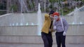 Magician showing magic trick to a mime with playing card