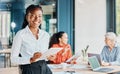 Im all prepped for the meeting. Cropped portrait of an attractive young businesswoman using her tablet while standing in Royalty Free Stock Photo