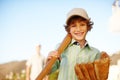 Im an all-rounder. Cropped portrait of a young boy playing baseball in the yard with his father in the background. Royalty Free Stock Photo