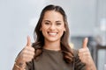 Im behind you. Cropped portrait of an attractive young businesswoman giving thumbs up while standing in the office. Royalty Free Stock Photo