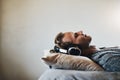 Im blocking out the world today. a handsome young man listening to music on his headphones while relaxing in bed at home Royalty Free Stock Photo