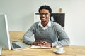 Im committed to excellence. Portrait of a young businessman working on a laptop in a modern office. Royalty Free Stock Photo