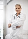 Im confident youll b cured. Cropped portrait of a mature female doctor working in her office in the hospital. Royalty Free Stock Photo