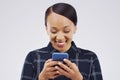 Im feeling all the emojis right now. Studio shot of a happy young woman using her cellphone.