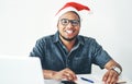 Im feeling festive and productive today. Portrait of a handsome young businessman working in his office on Christmas Eve