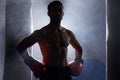 Im fight ready. Cropped portrait of a silhouetted young male boxer standing with his hands on his hips after a workout Royalty Free Stock Photo