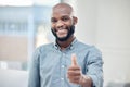 Im getting closer to success. a handsome young businessman standing alone in his office and making a thumbs up gesture.