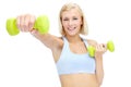 Im getting in shape. Sporty young woman lifting dumbbells while isolated on white. Royalty Free Stock Photo