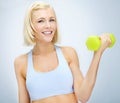 Im getting in shape. Sporty young woman lifting dumbbells while isolated on white. Royalty Free Stock Photo