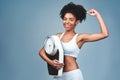 Im getting stronger and more confident by the day. Studio shot of an attractive young woman holding a weight scale.