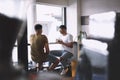 Im glad we met up for coffee. two young men talking while having coffee together in a cafe. Royalty Free Stock Photo