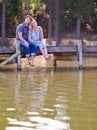 Im glad we took this time away. A loving married couple enjoying a moment on the jetty at the lake. Royalty Free Stock Photo