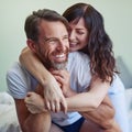 Im going to stay like this the whole day. a cheerful young couple embracing each other with a hug while relaxing on the Royalty Free Stock Photo