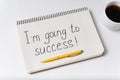 Im going to success notice. Notebook pen and cup of coffee on white background Royalty Free Stock Photo