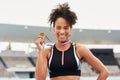 Im golden. Cropped portrait of an attractive young female athlete posing with her gold medal out on the track.