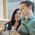 Im so happy by his side. a happy young couple relaxing on their couch at home. Royalty Free Stock Photo