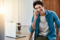 Im always happy to hear from you. Portrait of a man speaking on his cellphone while using his laptop in the kitchen. Royalty Free Stock Photo