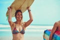 Im having the time of my life. a young surfer carrying her surfboard on her head. Royalty Free Stock Photo