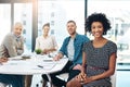 Im honoured to be working alongside the best in business. Portrait of a young businesswoman sitting in a meeting with Royalty Free Stock Photo