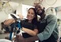 Im just the boyfriend of the bike master. a young couple standing together in their bicycle shop during the day. Royalty Free Stock Photo