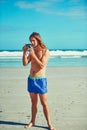 Im just here for the scenery. a young man spending the day at the beach.